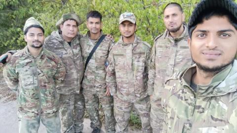 A group of discharged men near the Russia-Ukraine border on their way out