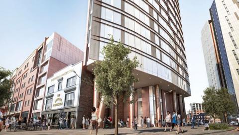 An artists impression of a tower block standing next to the Britons Protection pub in Manchester. The building is made of steel and glass, while the pub is an early 19th century three-storey building in white render with black outlines. 