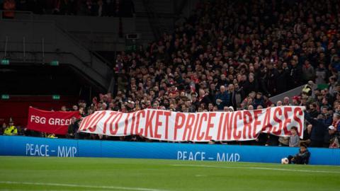 Liverpool hold a banner reading 'No to ticket price increases' on the Kop ahead of kick-off in a Uefa Champions League match