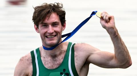 Paul O'Donovan celebrates after winning his third world single sculls title