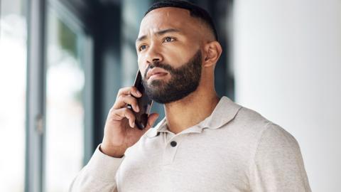 Businessman talking on a phone call listening and focused 
