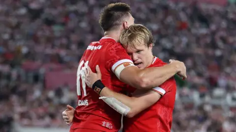 Josh Adams and Blair Murray celebrate 