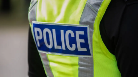 Generic image of a police vest being worn by an officer