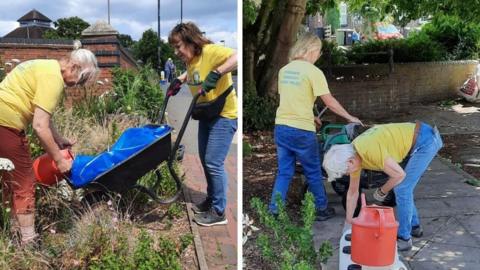 Volunteers work on areas of land in Bridgnorth. Two women are using a wheelbarrow near a patch of land next to a pavement and another team are planting in a paved area and using a red watering can. The volunteers have yellow T-shirts showing the group's name.