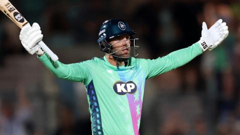 Donovan Ferreira stands arms aloft after hitting the winning runs