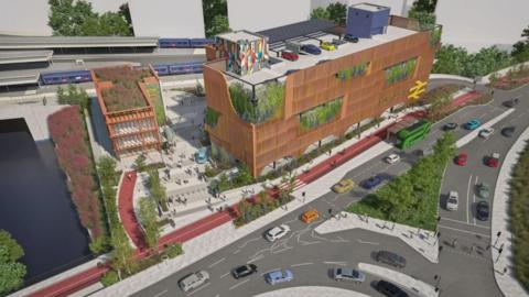 An artist's impression of a planned transport hub at Bristol Temple Meads Station. There is a large brown rectangular building with a red cycle path in front of it and cars driving along the road. A train line runs behind the building.
