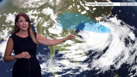 Elizabeth Rizzini in front of a BBC Weather map showing Violent Typhoon Yagi