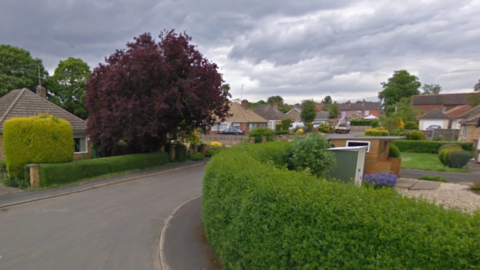 Road, bungalows and gardens in Orchard Way, West Winch