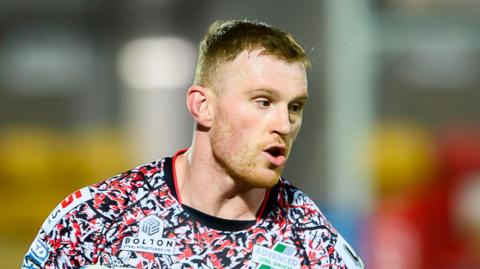 Head and shoulders image of Jack Hughes in action for Leigh Leopards