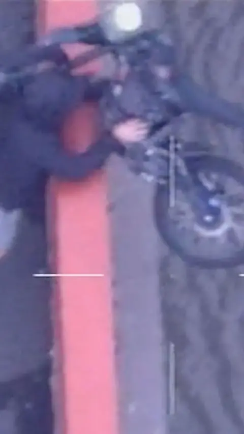 A man is seen throwing a vehicle off a bridge