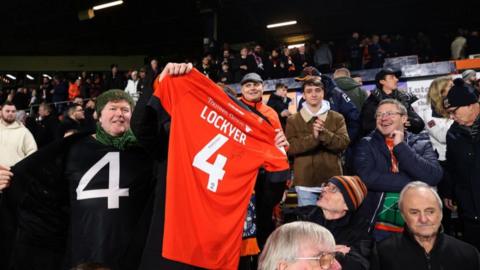 Fan holds up Tom Lockyer shirt