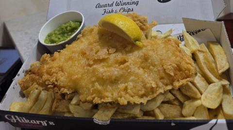 Fish and chips in a box, with mushy peas