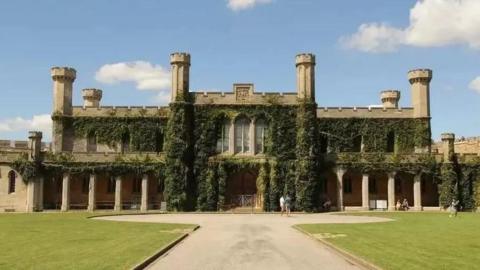Exterior view of Lincoln Crown Court with ivy climbing up the crenelated walls.
