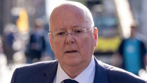 Peter Murrell is seen wearing a navy blue suit 