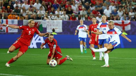 England's Beth Mead scores their fifth goal as Wales players try to defend by getting in front of the ball
