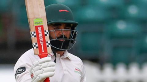 Ajaz Patel celebrates scoring fifty