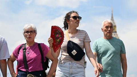  People are seen weaving fans at street near Big Ben in London, United Kingdom on July 1, 2025