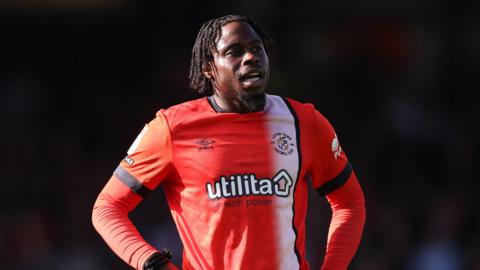 Luton's Pelly Ruddock Mpanzu with his hands on his hips