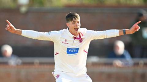 Archie Vaughan holds his arms out in celebration