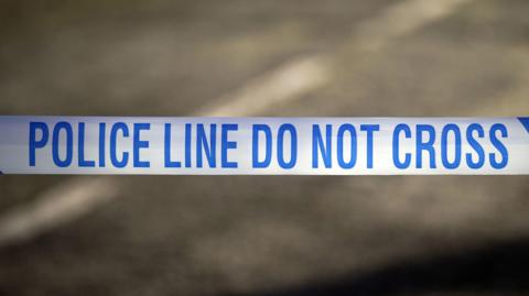 Generic image of blue and white tape containing the message: Police line do not cross.