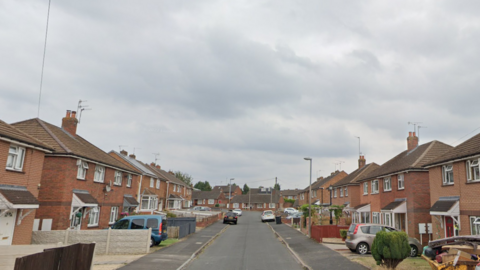 Cars parked outside houses in Haywharf Road in Pensnett