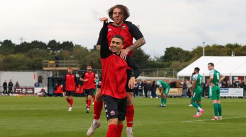 Jaze Kabia celebrates scoring for Truro City.