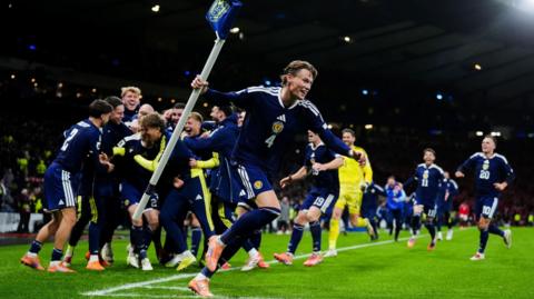 Scott McTominay celebrates with team-mates after Scotland's fourth goal scored by Kenny McLean during the Fifa World Cup European Qualifying match at Hampden Park in November 2025.