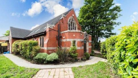 The red brick former church building