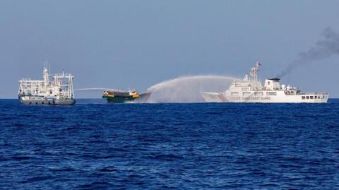 A file photo of two Chinese Coast Guard vessels blasting water cannons at a Philippine boat