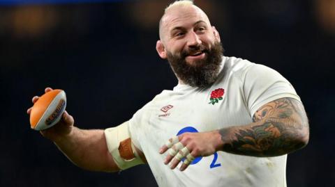 Joe Marler throwing a mini rugby ball.