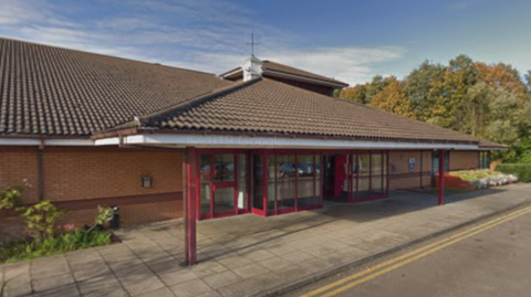 The outside of the Brook Hotel in Bowthorpe, near Norwich. It is a brick building with a red exterior.