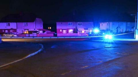 Night street view of incident location, Radford Steet, Worksop. Police cordon in place across street with residential houses.