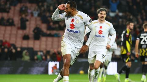 Nathaniel Mendez-Laing cups his ear in celebration