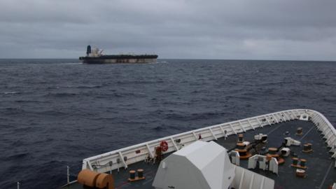 The shadow fleet ship Marinera seen in the distance from the upper decks of a US coastguard cutter following her.