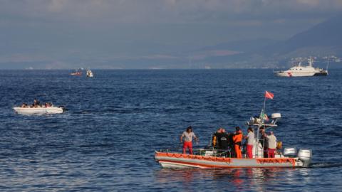 An Italian fire and rescue dive team on an inflatable boat on the water