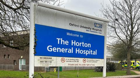 The welcome sign to The Horton General Hospital. There is also a sign pointing to the maternity unit.