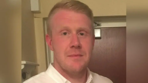 Close up image of Mr Cahalane. He is wearing a white shirt and is looking into the camera. 