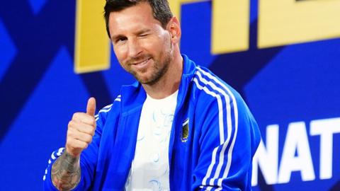 Lionel Messi winks during a press conference ahead of the FIFA World Cup 2026 Final match between Spain and Argentina at Fanatics Fest at Javits Center in New York