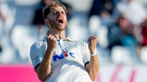 Ben Coad celebrates taking a wicket