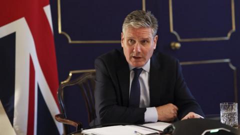 Sir Keir Starmer sat at a desk