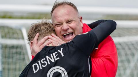Andy Morrison celebrates with John Disney