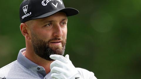 Jon Rahm with his hand on his chin