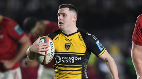 Dane Blacker on his way to scoring a try for Dragons
