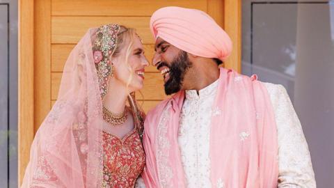 Newly-married couple dressed in traditional Sikh attire 