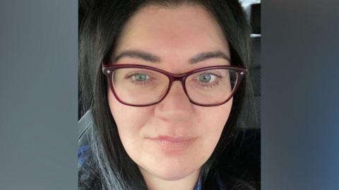 Selfie of Emma McLeod who had dark hair and wears glasses.