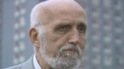 Adam McNaughtan - a bald man with a white/grey beard