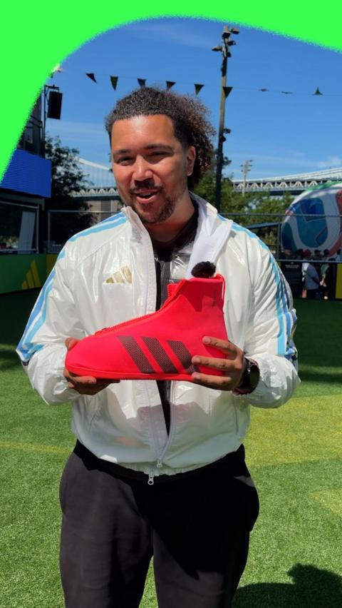 BBC Sport reporter holding shoes