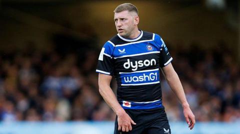 Finn Russell standing on the pitch during a match