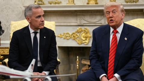 Mark Carney and Donald Trump sitting next to each other in the White House