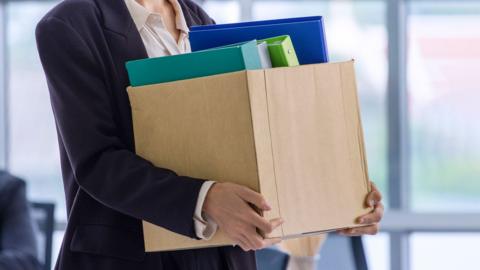 Employee holding box of items